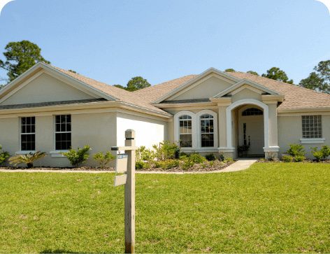 Home with a real estate sign in front